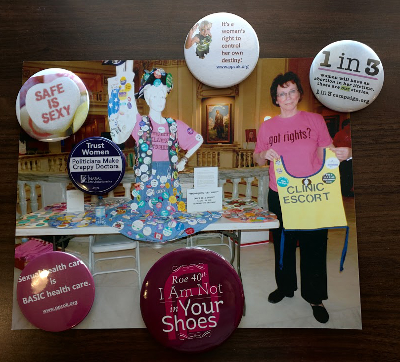 Reproductive rights activist Barbara Santee at the Oklahoma Capitol with her reproductive rights button collection, as displayed on a mannequin. Some of her buttons are seen here.