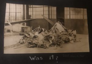Black and white photograph of a wrecked airplane with a caption that reads "Was it?"