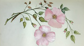 Pink flowers and greenery painted on a page in a book