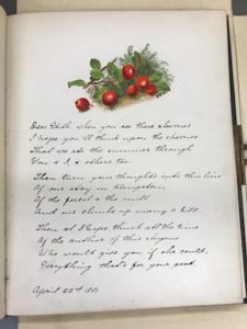 The page of a book containing a small painting of red berries and a paragraph note written in cursive