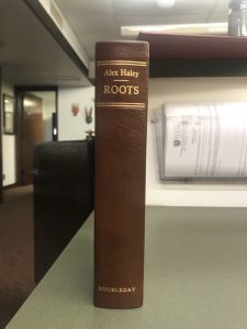 Image of the spine of a brown book with gold lettering. Roots by Alex Haley 