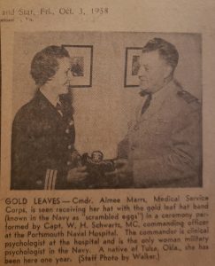 Photograph of a newspaper clipping featuring Aimee Whitman Marrs receiving a hat from a man and a caption underneath