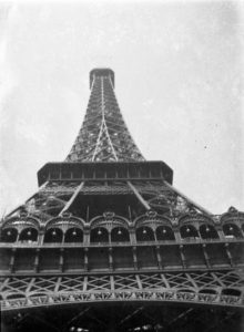 Black and white photo of the Eiffel Tower taken from below