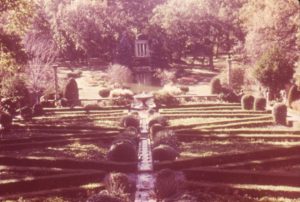 Colored photograph of gardens and a gazebo